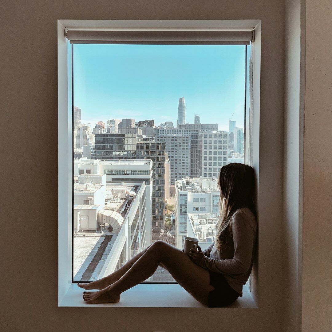 woman at window looking out
