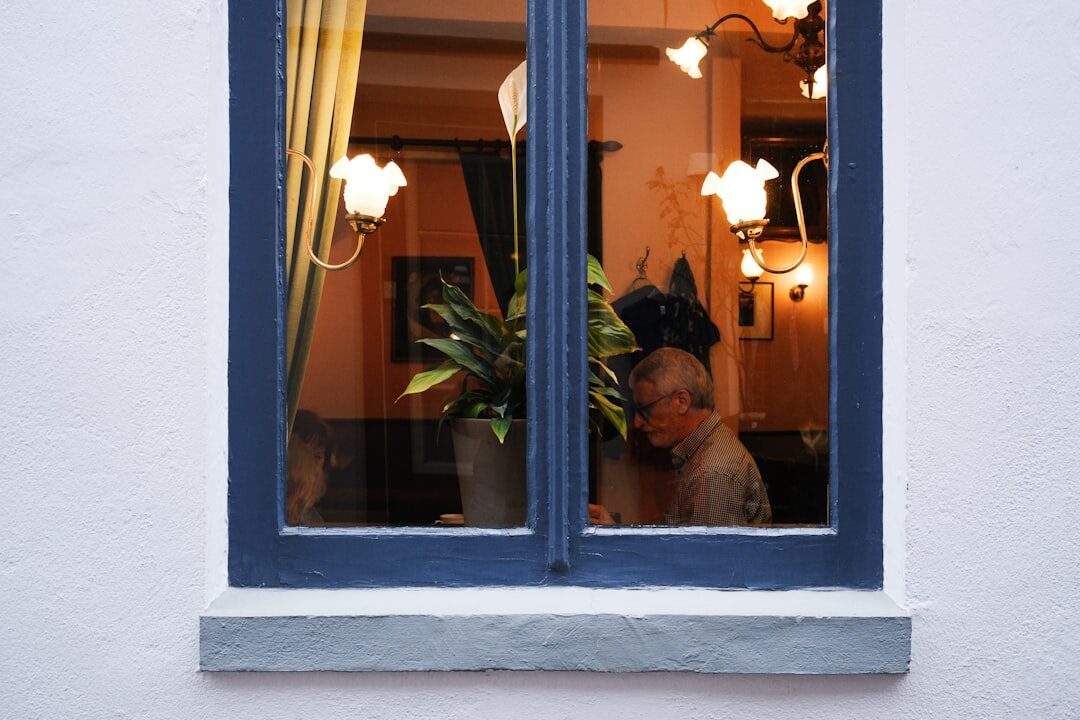 elderly woman looking out window